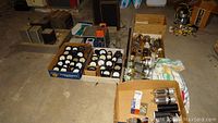 Overview of all items: trays of vacuum tubes, boxes of meters, electronic parts and transformer.