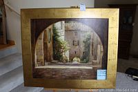 Framed Leonard Wren print showing an arched street scene with cobblestones and foliage.