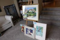 Overview of five paintings by Nyla Witmore displayed on floor and easel showing variety of sizes and frames
