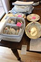 Full lot overview showing the boxed cups, salad plates, and serving bowl on a wooden table