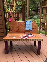 Front view showing overall bench appearance with deer backrest and seat surface