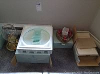 Two Partylite candleholders in original boxes, displayed together on floor