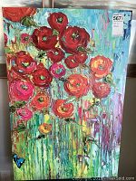 Full view of the floral wrapped canvas painting showing colorful flowers and abstract background.