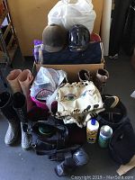 Full lot overview showing riding boots, helmets, blankets, grooming brushes, horse care items, and more.