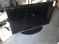 Full view of Toshiba 40 inch LED TV with stand in black finish showing screen and bezel.