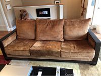 Full frontal view showing entire sofa with cushions and wood base