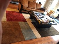 Full rug under coffee table and sofa, capturing pattern and overall layout