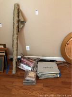 Overview of items including fabric roll, drapery rods, and packaged Storehouse draperies showing multiple items in the lot.