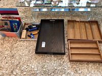 Wide view of all items spread out on carpet including wood trays, organizers, gift bags, flashlights, and chargers.