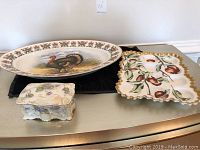 Photo of all three items together showing the large turkey platter, the small covered dish, and the deviled egg tray.