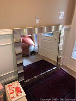 Front view of square wall mirror showing beveled edges and silver leaf frame.