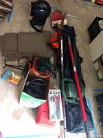 Overview of lot showing Black & Decker leaf blower, hedger, pole saw red rake handle, toolbox, extension cords, and car mats