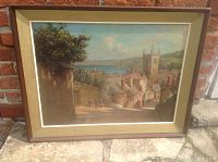 Frontal view of framed oil painting depicting village and bay scene