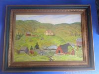 Framed oil painting showing full scene of Fishing Cove Nova Scotia in gilt frame on blue background