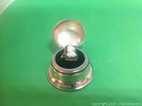 Ring seated in open Birks box on green background