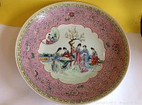 Top view of charger showing full famille rose enamel scene and pink floral border