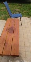 Wood bench with three wooden planks and floral decorative design in center
