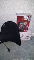 Photo of black inflatable back support pad and boxed HoMedics Shiatsu massager units.