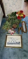 Full lot photo showing framed picture, mirror or tray, metal sconces, and various artificial flowers on carpet