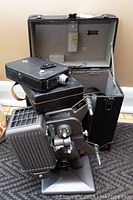 Overview of Kodak 8mm film projectors and cases showing overall condition, size, and finish.