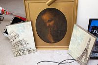 Framed oil painting with built-in lamp and two matching architectural print wall hangings shown together