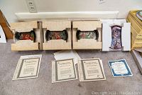 Three Russian collector plates and one Bunny Tales plate laid out with their respective certification documents in Russian.