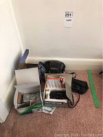 Five cameras with boxes and case arranged on carpet corner