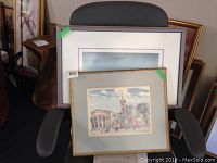 Two framed watercolour paintings, one smaller square gray frame with mark on top left corner, one larger rectangular gold frame