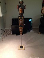 Full view of the five foot tall metal sculpture mounted on wooden base, showing the entire piece and its height relative to room items.