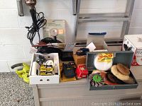 Overview of the lot showing submersible pump, brushes, hardware, and accessories.