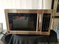 Front view of stainless steel Kenmore convection microwave oven with a glass door and control panel on the right side.