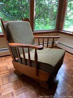 Front angled view of the vintage maple rocker/glider chair showing seat, armrest, backrest, and base.
