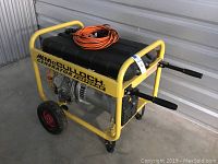 Side view of generator on wheels with extension cord coiled on top