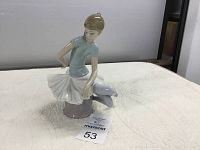 Front angled view of the ballerina figurine displaying detail of dress and face.