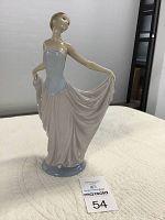 Front-left angle view of the Lladro dancer figurine on a white quilted surface.