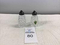 Pair of Waterford crystal salt and pepper shakers with metal tops, shown on a textured surface with lot number card
