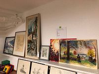 Overview of six framed and unframed wall art pieces on shelf