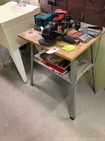 Overview photo showing two Makita palm sanders and one Craftsman disc sander on the workbench.