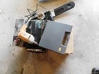 Overview of the tools including Black & Decker drill and green chain saw