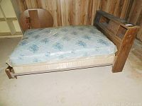 Full view of double bed with mattress and footboard, showing condition and overall structure of the bed frame