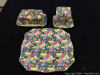 Photo showing the butter dish with lid and underplate, jam pot with underplate, and square plate in dense floral Hazel chintz pattern