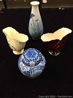 Front image of all four items: the Royal Copenhagen vase, Delft ginger jar, and two Carlton Ware vases