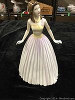 Front view of the porcelain figurine showing the full dress and facial features