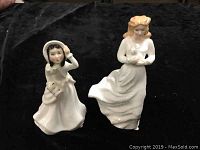 Two Royal Doulton figurines: Loving You HN3389 and Helen HN2994, displayed on dark cloth