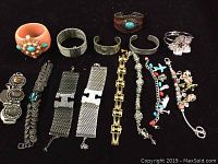 Photo showing all 14 bracelets arranged in a row with clear visibility of various styles and colors.
