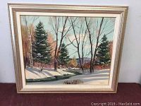 Full view of the framed winter landscape oil painting featuring snow, trees, and a creek.