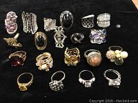 Full lot of twenty assorted rings arranged on black background