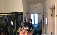 Front view of chainmail headpiece worn by a person showing lattice pattern on forehead and head