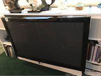 Front view of the 50-inch Panasonic plasma TV mounted on a wall mount.