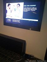 65 inch Samsung LED TV mounted on wall, display powered on